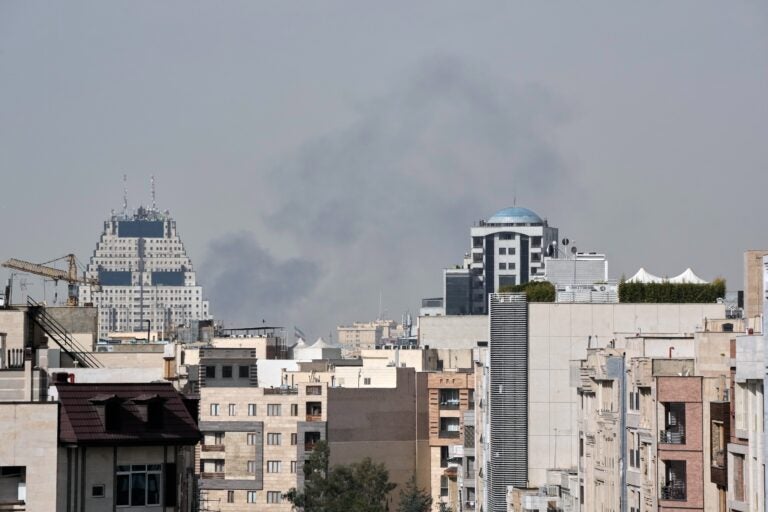 Smoke can be seen in the background of the downtown skyline in Tehran after an explosion