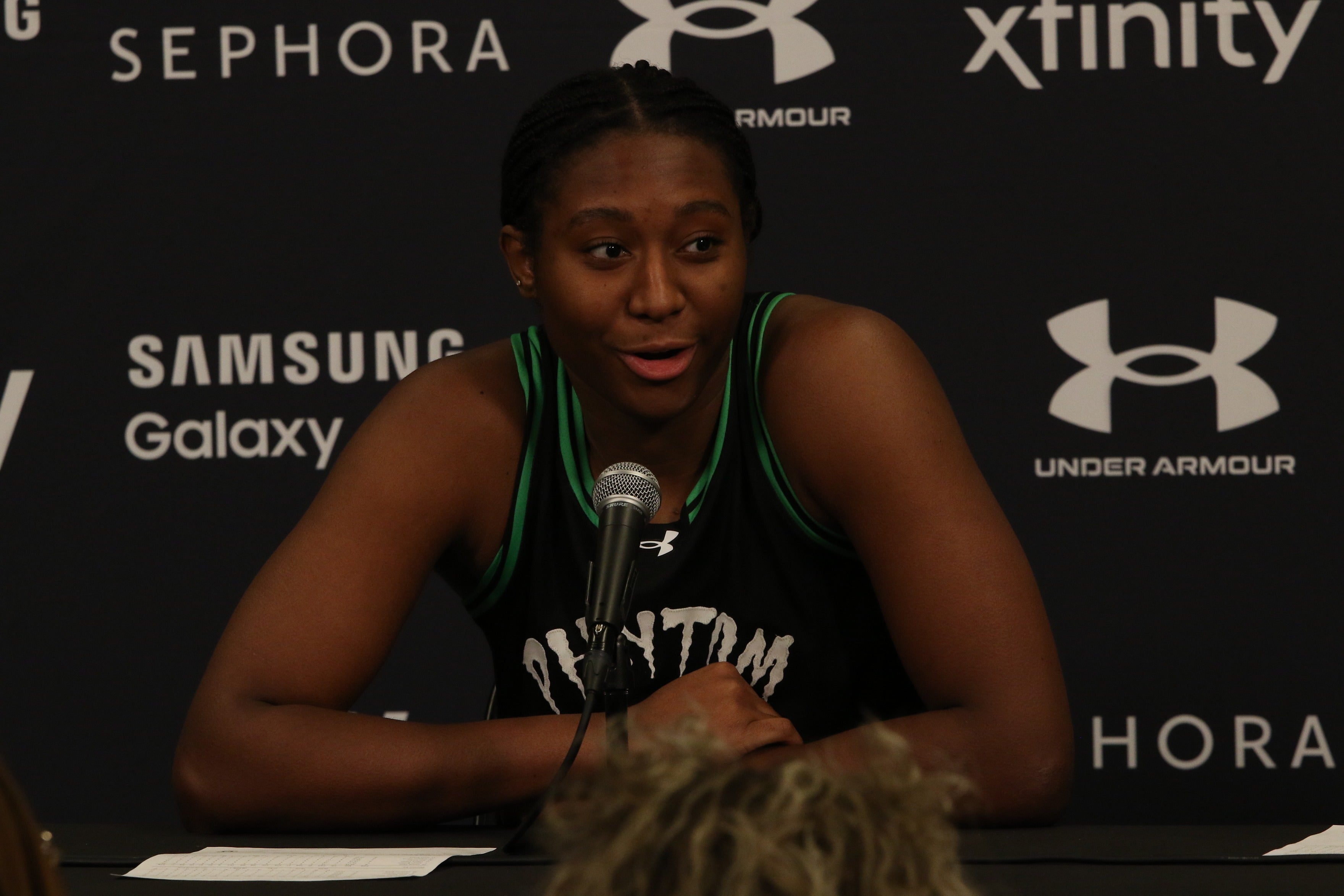 Aliyah Boston speaks into a microphone