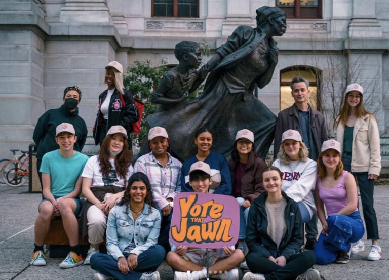 Vote That Jawn student members pose with a sign that reads 