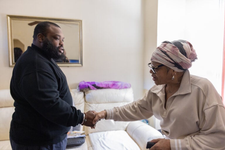 Jordan Harris shakes hands with Jacqueline Percell