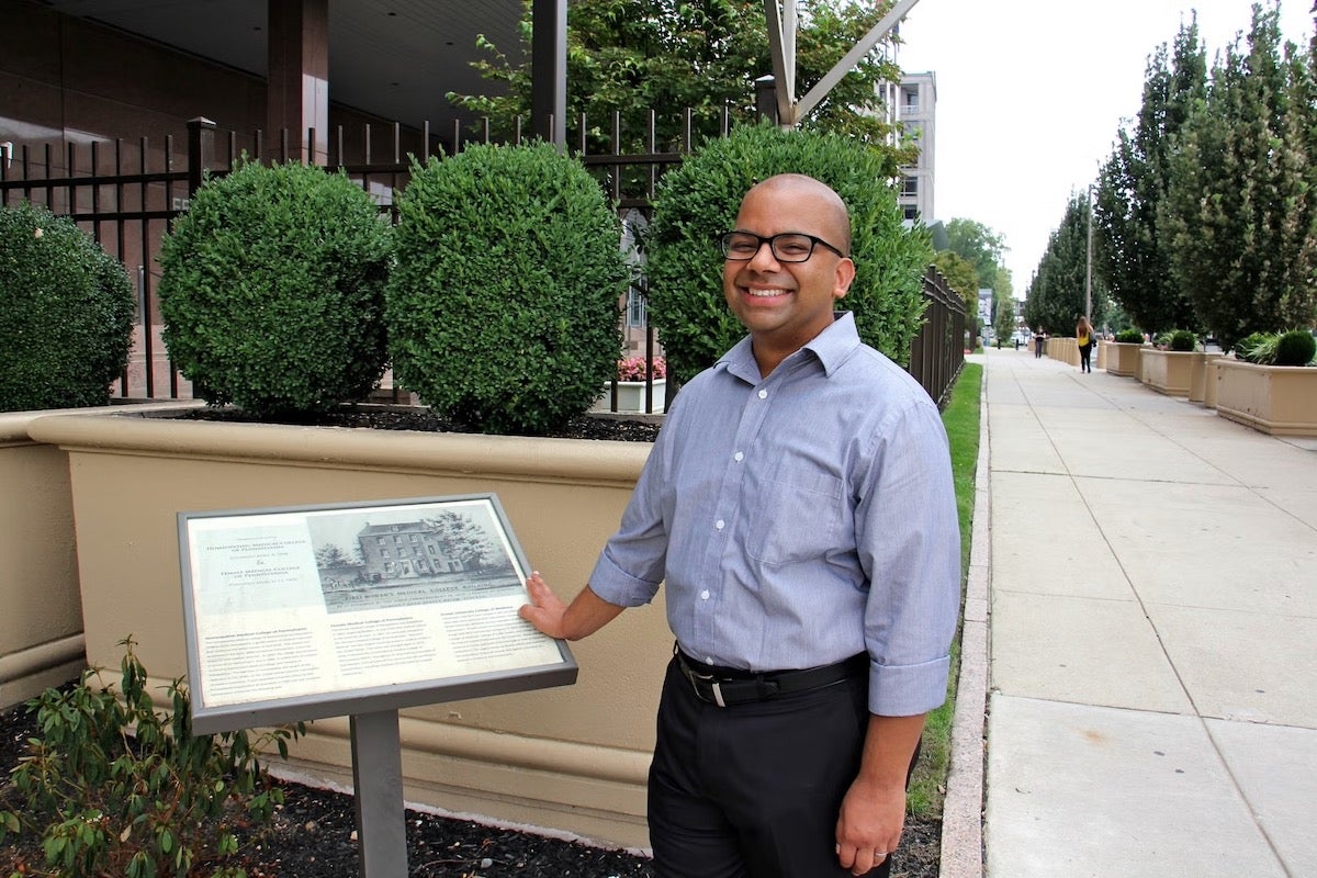 Samip Mallik posing for a photo at 6th and Arch memorial