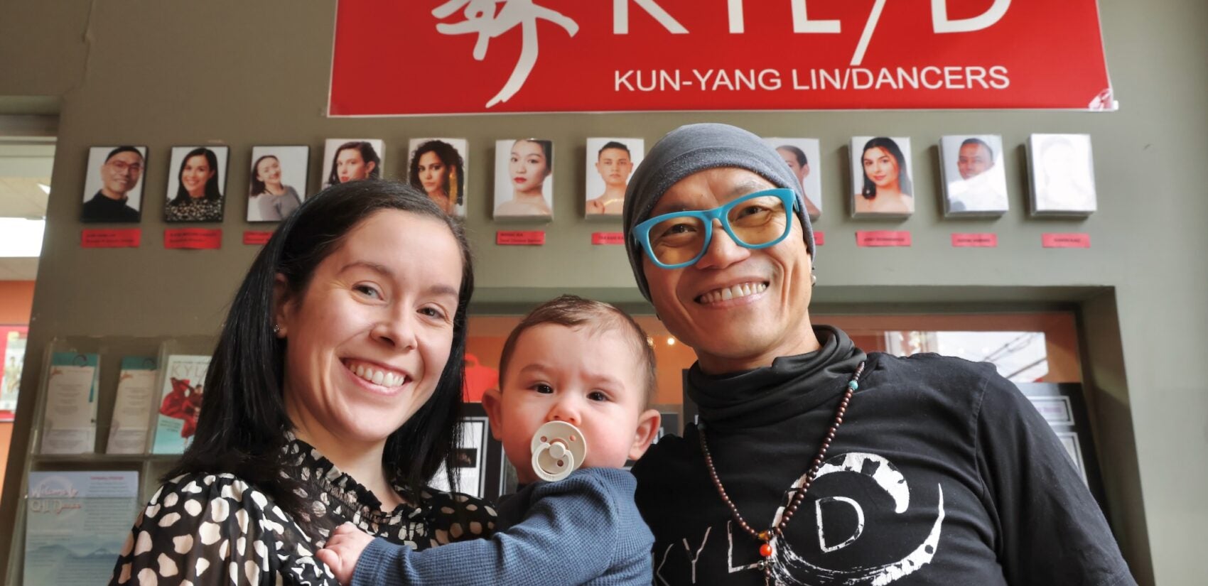 Kun-Yang Lin and Katie Moore-Derkits smile with her baby son