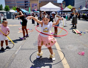 2025-06-19-e-lee-child-philadelphia-african-american-museum-juneteenth-block-party-hula-hoop-file A 5-year-old hula hoops at a block party