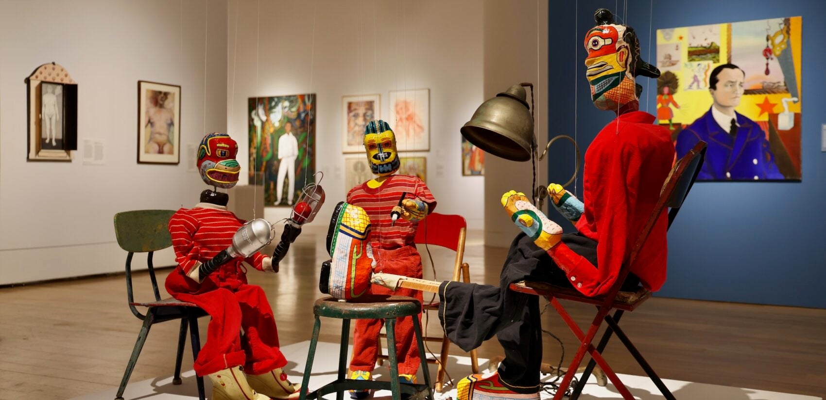 A grouping of papier-mâché marionettes by Karl Wirsum