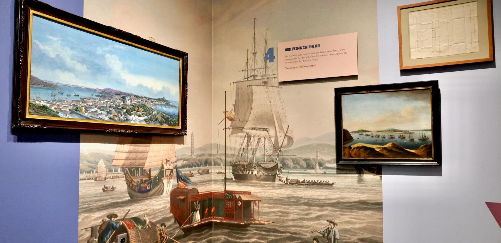 A large illustration of the port of Guangzhou is split between two walls in a corner.