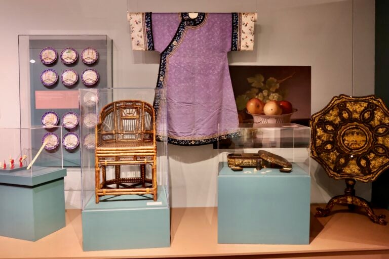 Various Chinese items on display, including a chair, painting.
