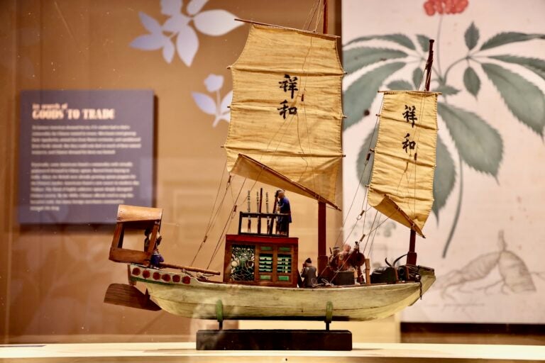 A model boat with Chinese letters displayed on the sails.