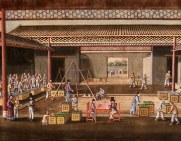 A close-up shot of a painting depicting people trading goods at a market