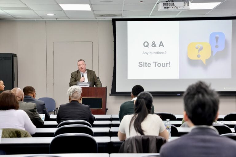 Jason Kavulich is speaking at podium while giving a presentation.