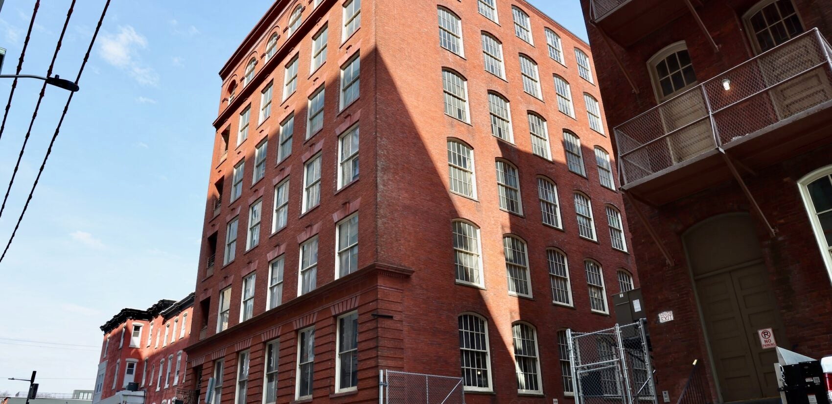 The exterior of a large brick building is shown.