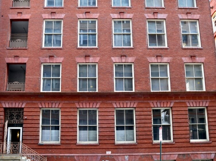 The exterior of a large brick building is shown.