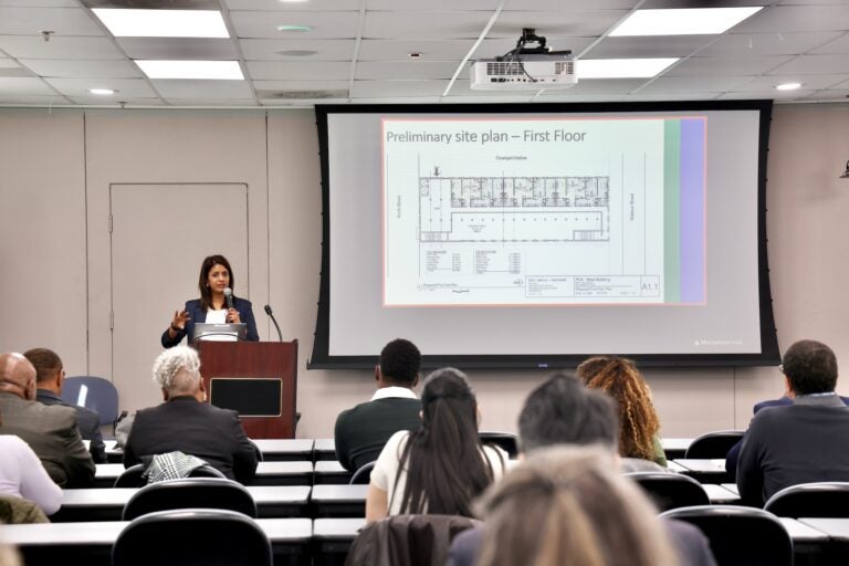 Vidhi Anderson is speaking at a podium and giving a presentation.