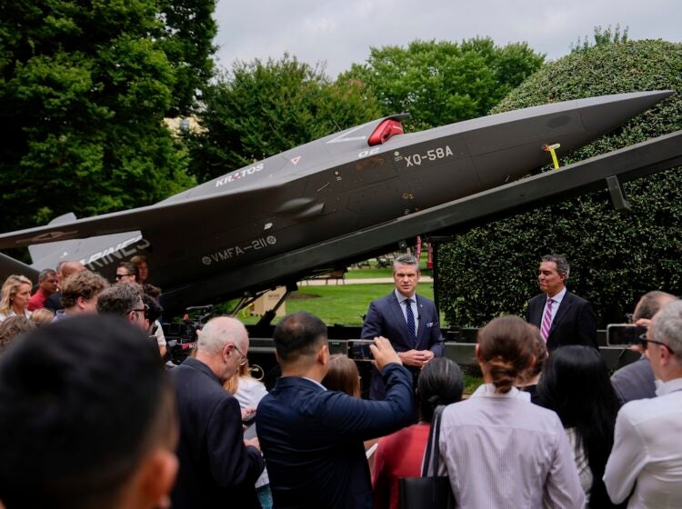 Secretary of Defense Pete Hegseth and Under Secretary of Defense for Research and Engineering Emil Michael speak to reporters before looking at a display of multi-domain autonomous systems in the Pentagon courtyard, Wednesday, July 16, 2025, in Washington. (AP Photo/Julia Demaree Nikhinson)