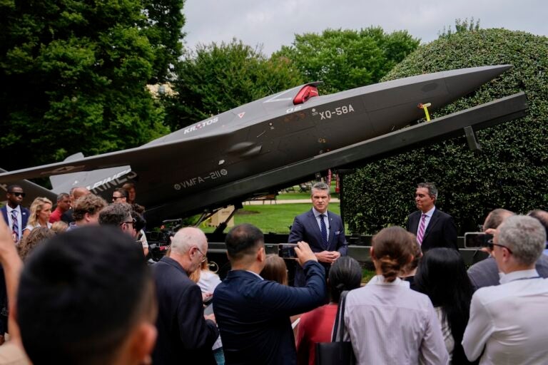 Secretary of Defense Pete Hegseth and Under Secretary of Defense for Research and Engineering Emil Michael speak to reporters before looking at a display of multi-domain autonomous systems in the Pentagon courtyard, Wednesday, July 16, 2025, in Washington. (AP Photo/Julia Demaree Nikhinson)