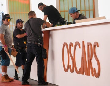 Crew members work on a decorative wall near the red carpet for Sunday's Oscars telecast, on Wednesday, March 11, 2026, at the Dolby Theatre in Los Angeles. (AP Photo/Chris Pizzello)