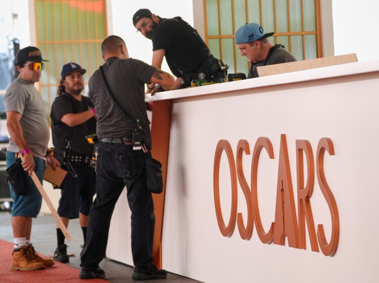 Crew members work on a decorative wall near the red carpet for Sunday's Oscars telecast, on Wednesday, March 11, 2026, at the Dolby Theatre in Los Angeles. (AP Photo/Chris Pizzello)