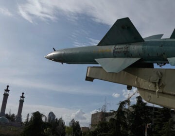 A missile is displayed in a permanent exhibition at a recreational area as minarets of a mosque are seen at rear, in northern Tehran, Iran, Tuesday, March 24, 2026. (AP Photo/Vahid Salemi)