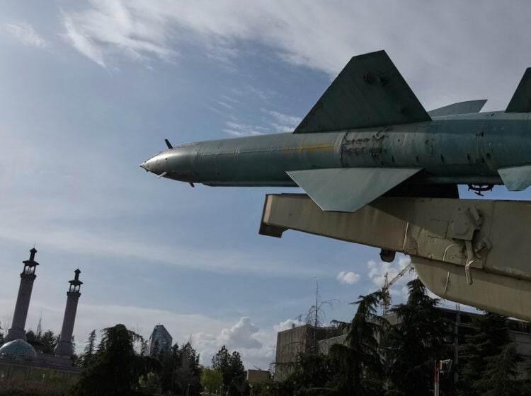 A missile is displayed in a permanent exhibition at a recreational area as minarets of a mosque are seen at rear, in northern Tehran, Iran, Tuesday, March 24, 2026. (AP Photo/Vahid Salemi)
