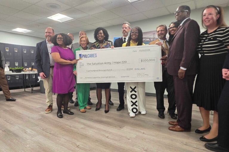 Mayor Cherelle Parker holds a $500,000 check with others