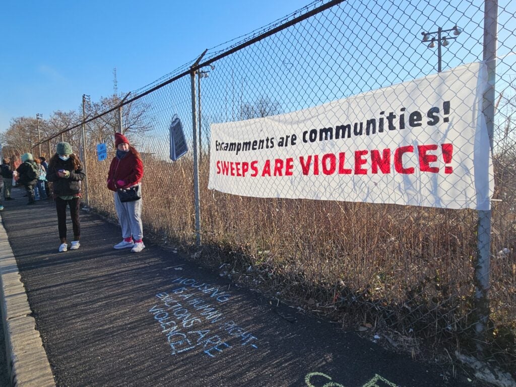 Supporters hung up a sign urging better treatment of those in the encampment.