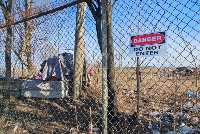 A sign on a fence reads Danger Do NOt Enter