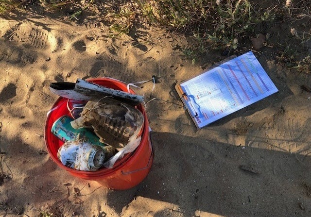 A bin filled with trash picked up on the beach.