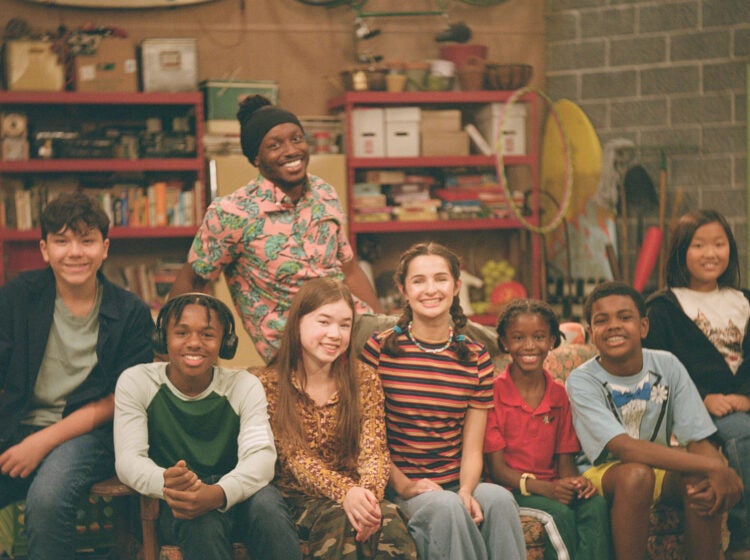 The cast of Good Neighbor Club sitting on a couch.