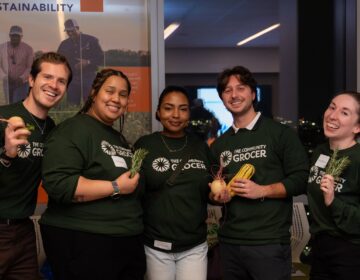 community-grocer-2026-03-27-2 5 people posing for a photo together.