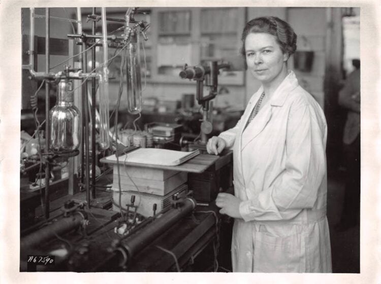 Katharine Burr Blodgett, in her laboratory, examines a tube that was coated to make the glass non-reflecting, circa 1935. (Courtesy of the Museum of Innovation and Science)