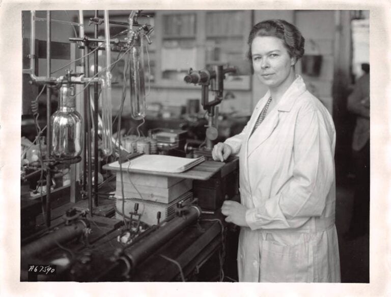 Katharine Burr Blodgett, in her laboratory, examines a tube that was coated to make the glass non-reflecting, circa 1935. (Courtesy of the Museum of Innovation and Science)