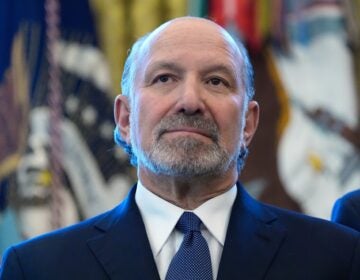 Howard Lutnick looks on