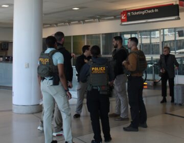 ice-philadelphia-airport-en-032426-4 ICE agents standing and talking at the Philadelphia airport.