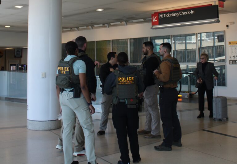 ICE agents standing and talking at the Philadelphia airport.