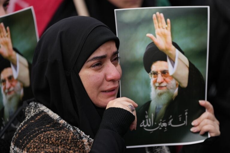 A woman cries as she mourns the death of Iranian Supreme Leader Ayatollah Ali Khamenei