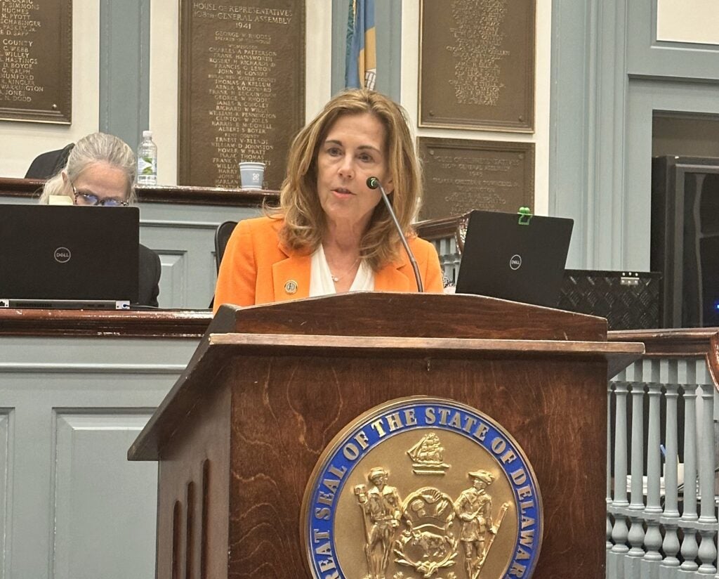 Kathy Jennings speaking at a podium.