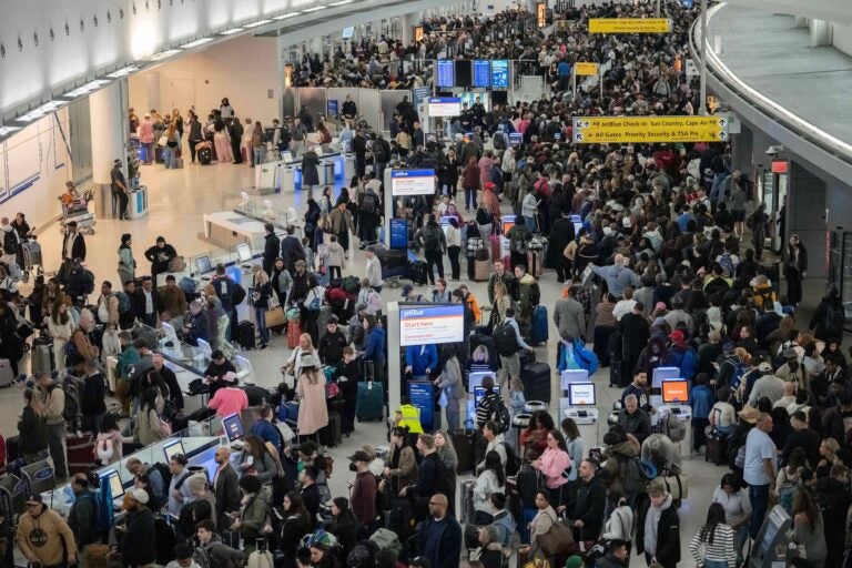 People wait in a TSA line at the John F. Kennedy International Airport