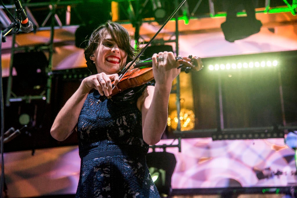 Kiana Weber of Gaelic Storm plays violin on stage
