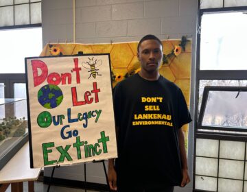 lankenau-school-closure-protest-philadelphia-1 Messiah Stokes next to a sign reading Don't Let Our Legacy Go Extinct