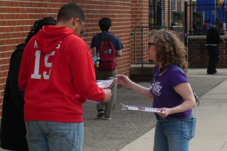 Students and parents outside Bluford Elementary School with Lift Every Voice Philly promoters