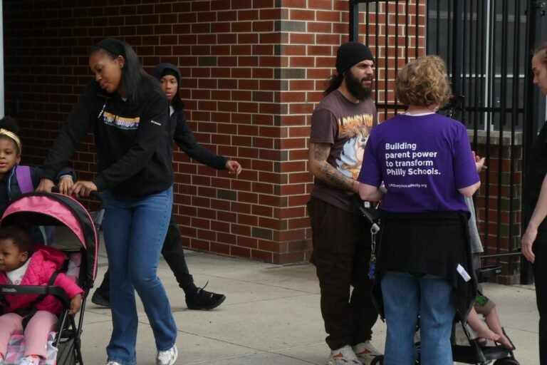 Students and parents outside Bluford Elementary School with Lift Every Voice Philly promoters
