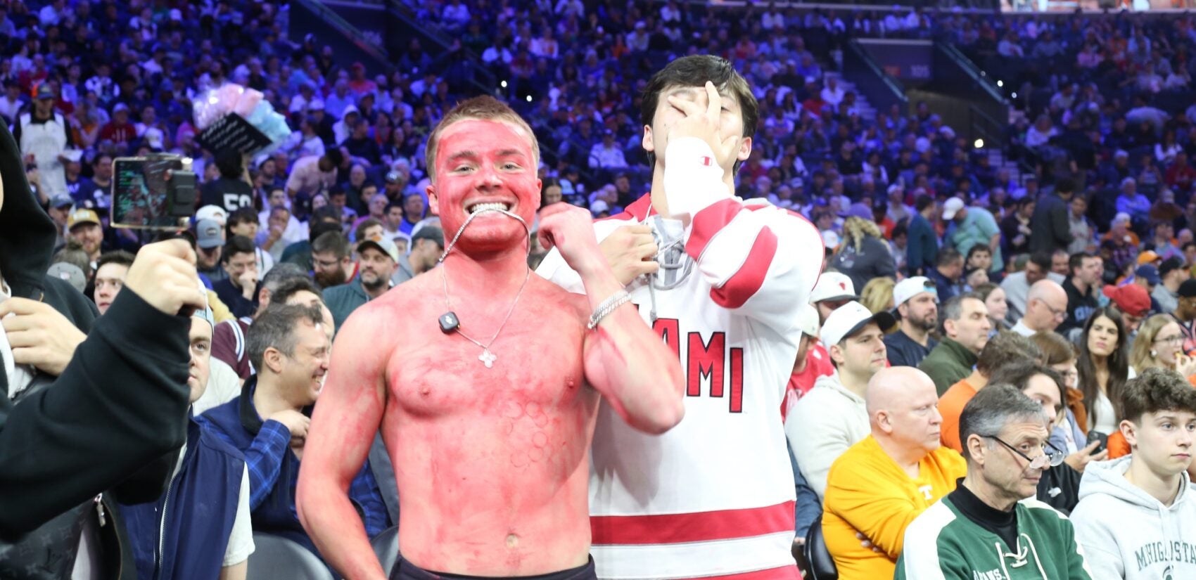 a Miami Redhawks fan covered in red paint