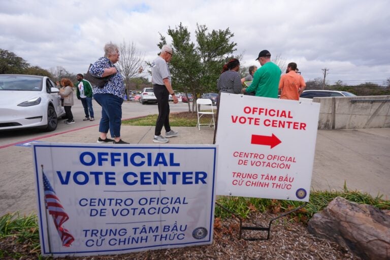 Primary voters arrive to cast ballots at an official vote center