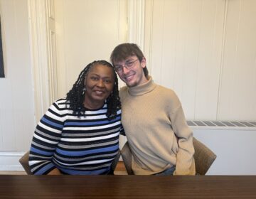 Ms. Julia and Jackson Tignor posing for a photo together while sitting next to each other at a table.