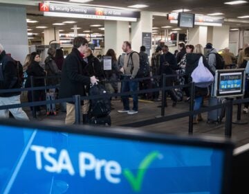 passengers wait in line at a Transportation Security Administration checkpoint at the Philadelphia International Airport