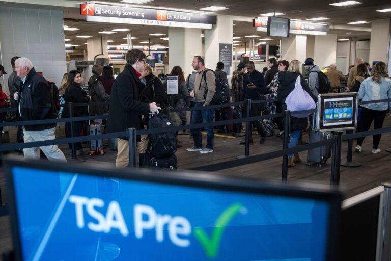 passengers wait in line at a Transportation Security Administration checkpoint at the Philadelphia International Airport