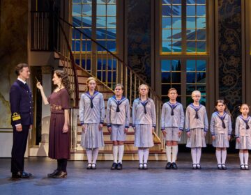 Kevin Earley (Captain Georg von Trapp) and Cayleigh Capaldi (Maria Rainer) with the von Trapp Children