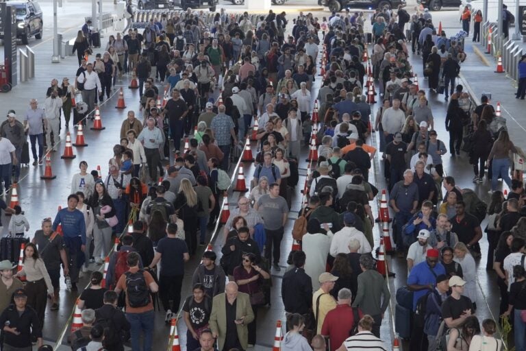 Travelers line up at a TSA checkpoint at George Bush Intercontinental Airport in Houston, Thursday, March 26, 2026.