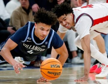Villanova guard Tyler Perkins dives for a basketball