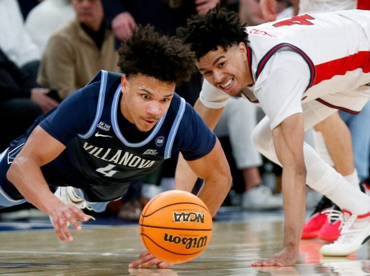 Villanova guard Tyler Perkins dives for a basketball