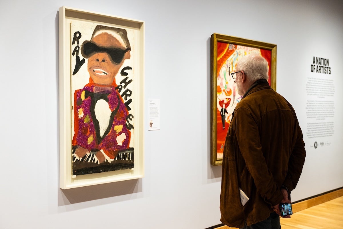 Man viewing Ray Charles piece at the Nation of Artists exhibit